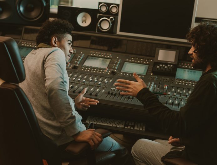 young musicians talking at recording studio